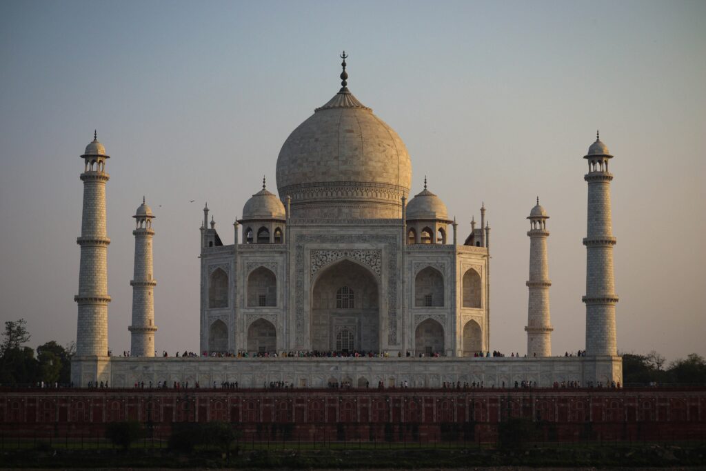 The iconic Taj Mahal, an architectural marvel in Agra, India, basking in sunset light.